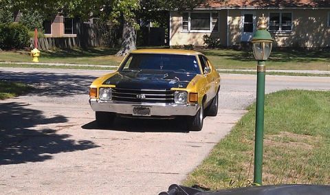 1979 Ford Bronco - A yellow and black coupe, likely a 1973 model, is parked in a driveway with a black hood scoop.