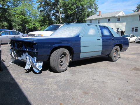 1991 Ford LTD Crown Victoria - A 1991 Ford Crown Victoria LTD is partially painted, with the front end masked off for protection.