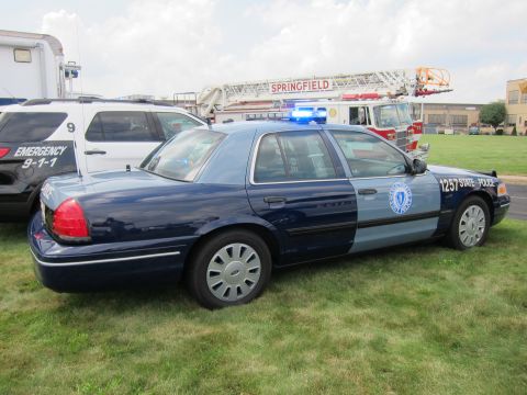 1991 Ford LTD Crown Victoria - blue-gray Ford Crown Victoria State Police sedan numbered 1257 with roof lights and door seal sits on grass.