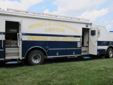 1991 Ford LTD Crown Victoria - side of a blue-and-white Mobile Command Center truck lettered Springfield Police Department, with an open door and step.