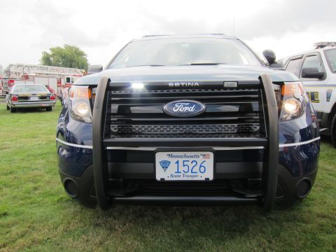 1991 Ford LTD Crown Victoria - head-on front of a blue Ford Explorer State Police SUV with a Setina push bar and a Massachusetts 1526 trooper plate.