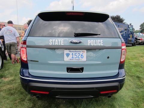 1991 Ford LTD Crown Victoria - Rear view of a light-and-dark-blue Ford Explorer police SUV marked STATE POLICE, with a Massachusetts State Trooper plate at an outdoor car…