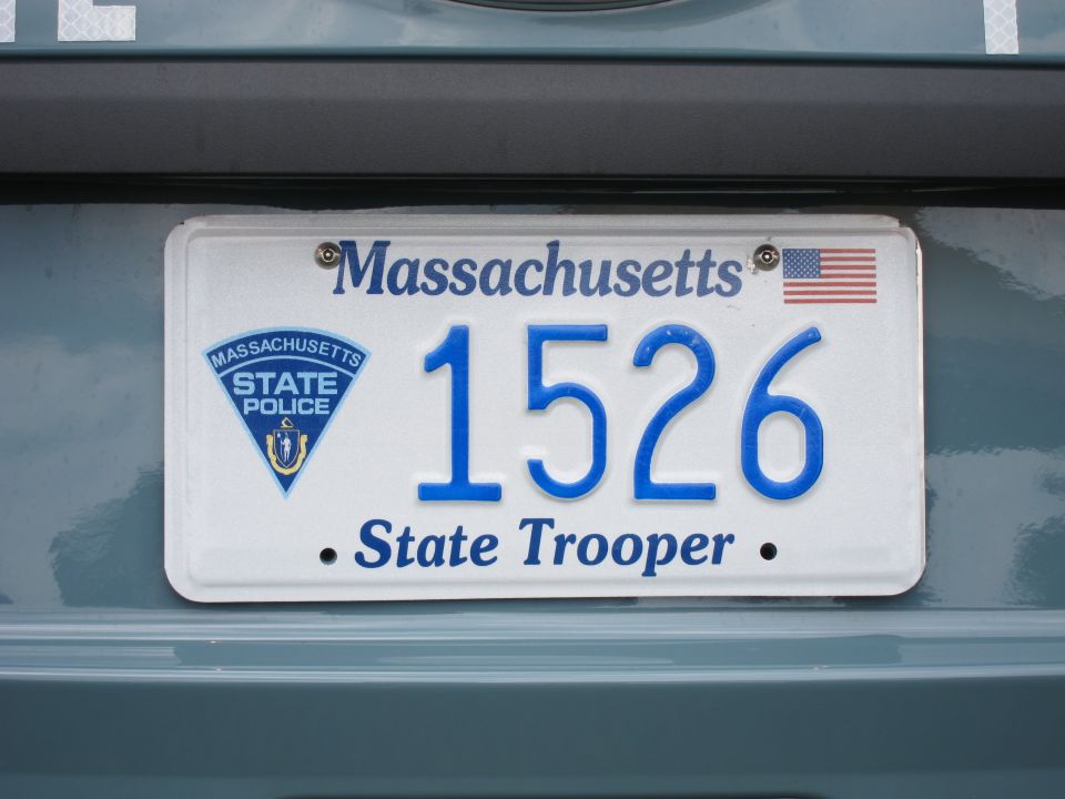 Massachusetts State Trooper plate 1526 mounted on a light-blue vehicle body panel