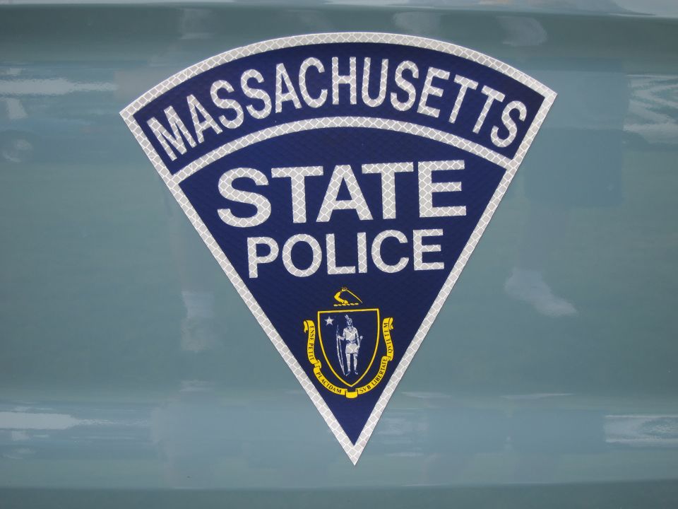 Massachusetts State Police triangular reflective decal with state seal on a blue-green panel