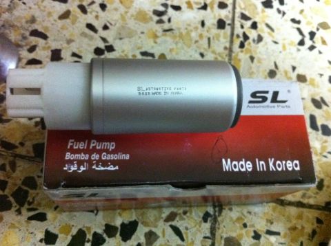 1998 Ford Crown Victoria - A silver fuel pump is shown with its packaging, which indicates it is made in Korea.