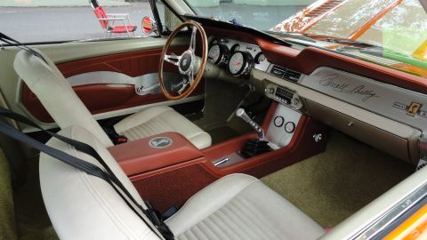 1964 Ford Fairlane - Interior view of a classic car, showing the dashboard with 'Carroll Shelby' badging and a wood-rimmed steering wheel.