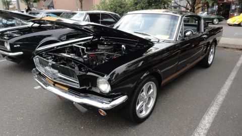 1964 Ford Fairlane - A black 1965 Ford Mustang is displayed with its hood open at a car show.