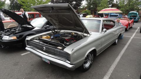 1964 Ford Fairlane - Several classic cars are displayed with their hoods up at an outdoor event.