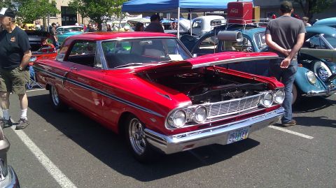 1964 Ford Fairlane - A red 1964 Ford Fairlane is displayed at an outdoor car show with its hood open.