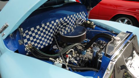 1964 Ford Fairlane - Custom engine bay features a blue and white checkered pattern on the firewall and a chrome radiator.