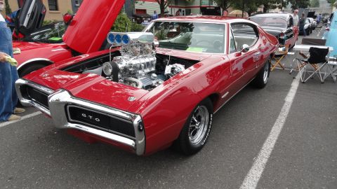 1964 Ford Fairlane - Blown 1969 Pontiac GTO on display, with another custom car nearby.