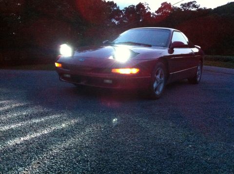1994 Ford Probe - This 1994 Ford Probe is shown in a front 3/4 view with its headlights illuminated.