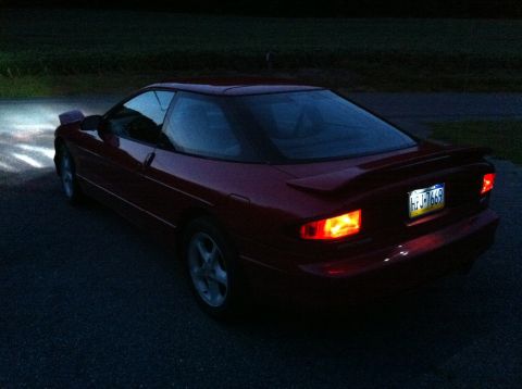1994 Ford Probe - Rear 3/4 view of a red 1994 Ford Probe coupe with its brake lights illuminated.