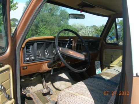 1979 Ford F-150 - The interior of a 1979 Ford F-150 shows the dashboard, steering wheel, and seats.