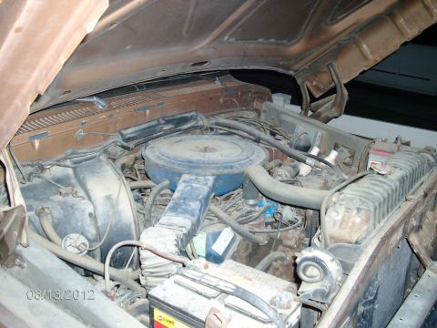 1979 Ford F-150 - View of the engine compartment, showing various engine components and the battery.