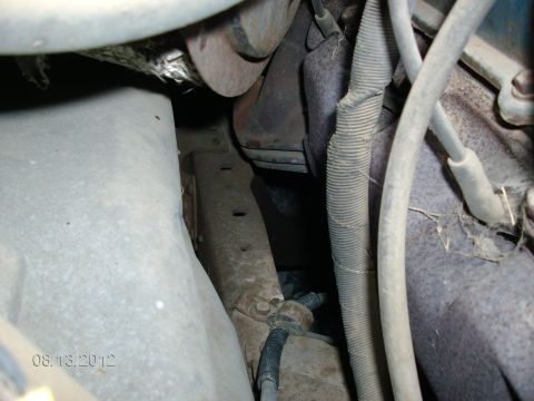 1979 Ford F-150 - A close-up view of various engine components and wiring harnesses within a vehicle's engine bay.