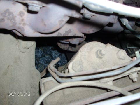1979 Ford F-150 - Close-up view of engine components, including exhaust manifold and bolts, with visible date stamp.
