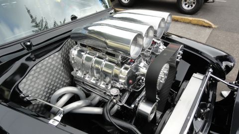 1964 Ford Fairlane - A highly polished V8 engine with a prominent supercharger and four carburetors is visible under the hood.