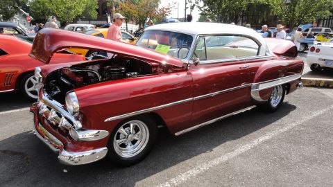 1964 Ford Fairlane - This classic car, likely a 1954 model, is displayed with its engine compartment open at a car show.