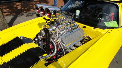 1964 Ford Fairlane - Close-up of a highly modified V8 engine a supercharger and triple carburetors.