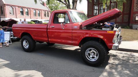 1964 Ford Fairlane - This red 1977 Ford F-150 pickup truck is displayed with its hood open, revealing the engine bay.