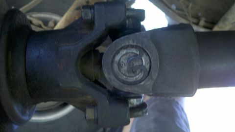 1978 Ford Bronco - Underside view of a vehicle's driveshaft universal joint, showing mechanical components.