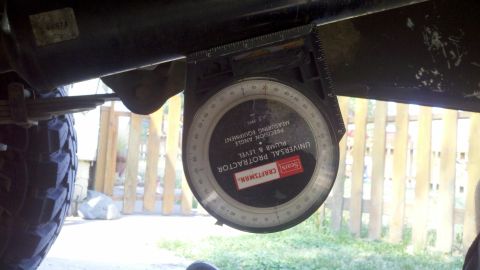 1978 Ford Bronco - A Sears Craftsman protractor is used to measure the angle of a vehicle's suspension component.