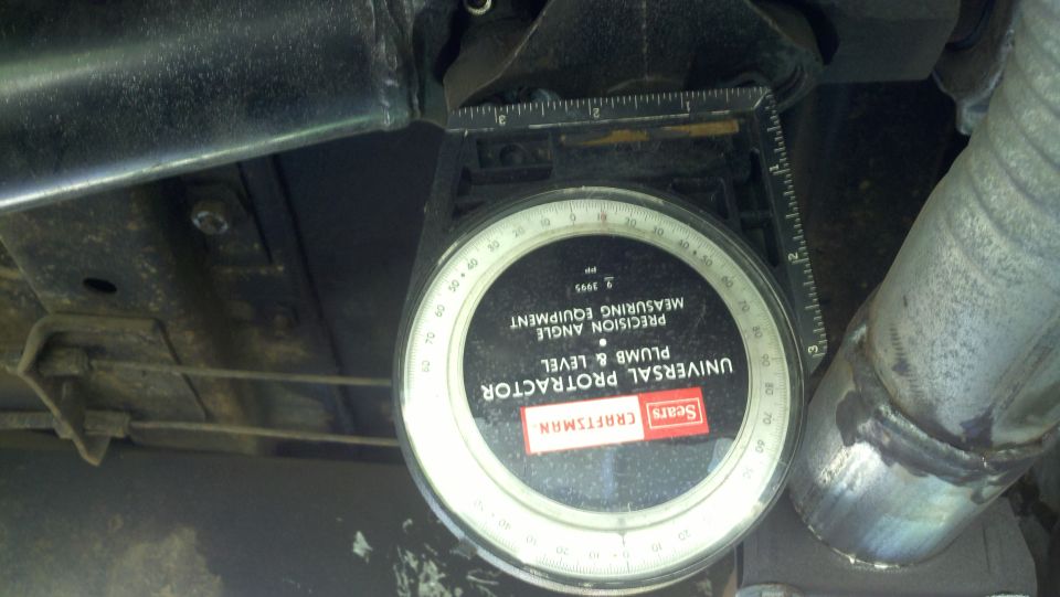 Sears Craftsman universal protractor plumb & level measuring angle on vehicle undercarriage near exhaust pipe