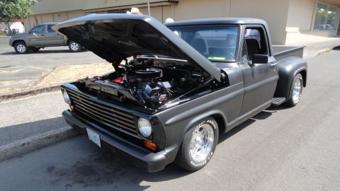 1964 Ford Fairlane - This matte gray pickup truck, likely a 1967 model, is displayed with its hood open, revealing the engine bay.