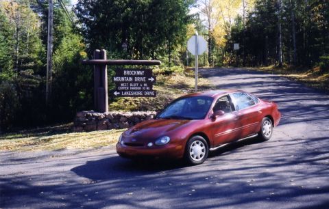 1997 Ford Taurus - Red 1997 Ford Taurus parked by a sign for Brockway Mountain Drive.