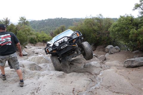 1985 Toyota 4Runner - An off-road SUV navigates a rocky trail, demonstrating its climbing capability.