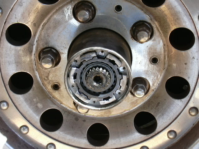 Locking hub cap removed exposing splined axle shaft and hub internals on alloy wheel