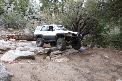 1985 Toyota 4Runner - This modified Toyota 4Runner navigates a challenging rocky terrain, demonstrating its off-road capabilities.