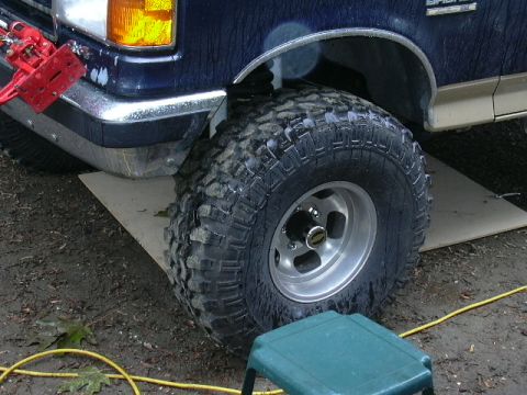1991 Ford Bronco - Close-up of the front bumper and a large off-road tire on a 1991 Ford Bronco.
