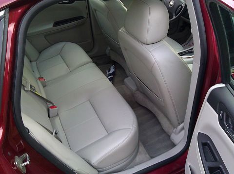 2008 Chevrolet Impala - Interior view of a 2008 Chevrolet Impala, highlighting the rear seating area and tan leather upholstery.