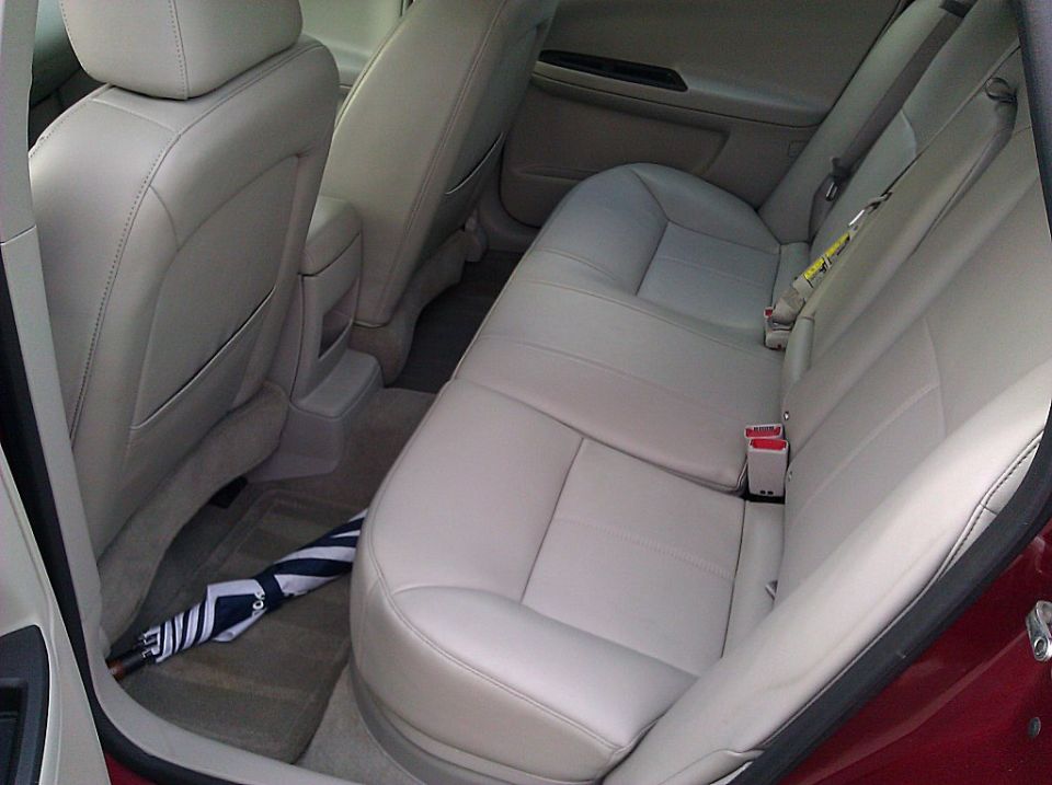 Car interior showing back seats and an umbrella on the floor