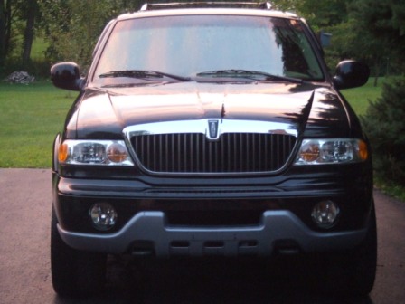 1996 Ford Bronco - Black Lincoln Navigator parked outdoors, showing its front grille and headlights.