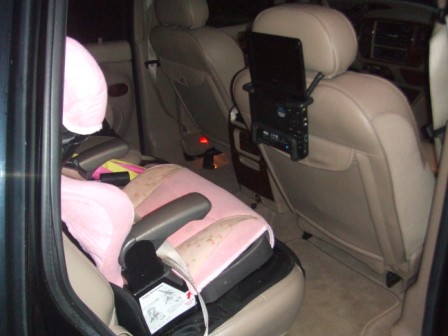 1996 Ford Bronco - Interior view of a vehicle equipped with child safety seats and a rear-seat entertainment system.