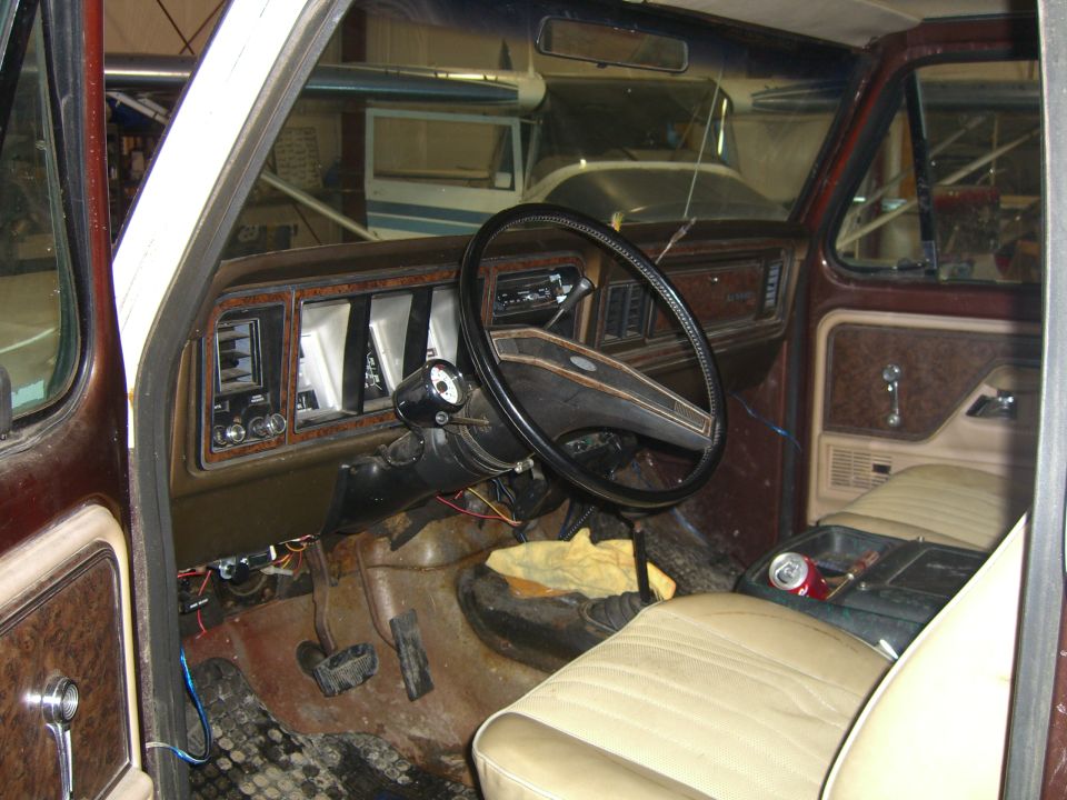 Interior view of a 1979 Ford Bronco showing dashboard, steering wheel, and seats