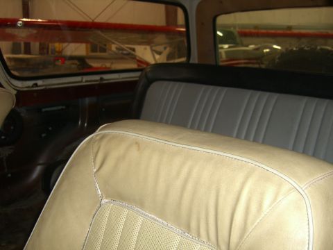1979 Ford Bronco - Interior view of a 1978 Ford Bronco, with seats and windows reflecting an airplane hangar.