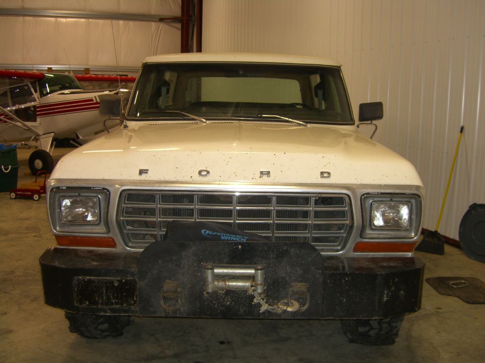White 1979 Ford Bronco front view with a winch mounted on the bumper