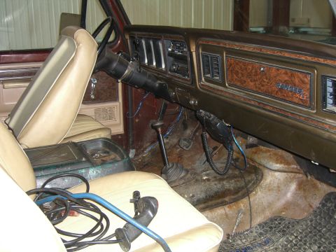 1979 Ford Bronco - The interior of a 1979 Ford Bronco displays its dashboard with woodgrain accents and tan upholstery.