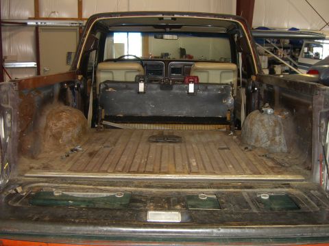 1979 Ford Bronco - The rear view of a 1978 Ford Bronco shows its interior and cargo area, with visible rust in the bed.