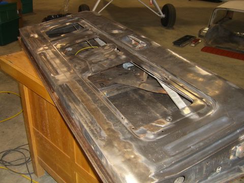 1979 Ford Bronco - The interior of a car door, showing its mechanical components, is displayed on a workbench.