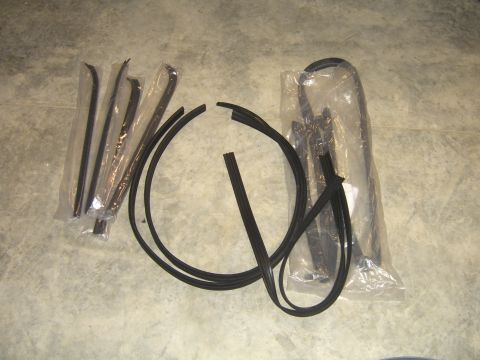1979 Ford Bronco - Various rubber seals and trim pieces are displayed on a concrete surface, some still in packaging.