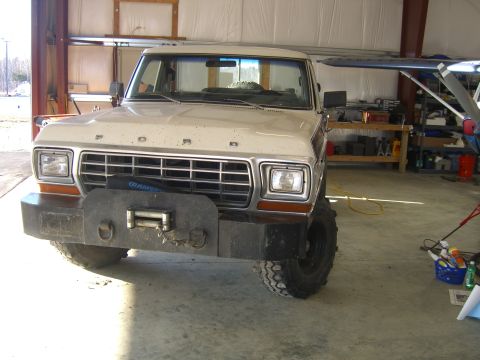 1979 Ford Bronco - This Ford Bronco, likely a 1978 model, is equipped with a heavy-duty bumper and winch, parked indoors.