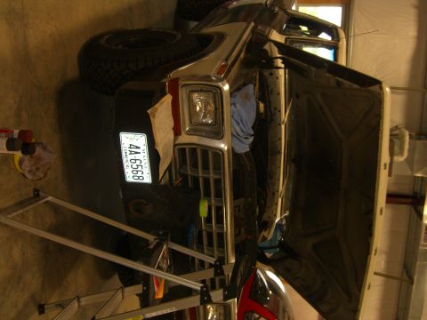1979 Ford Bronco - The front of a 1979 Ford Bronco is visible with its hood open, revealing the engine bay. The vehicle has a chrome grille and a Maine licens…