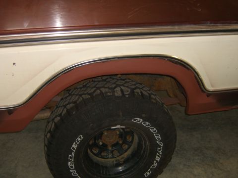 1979 Ford Bronco - A close-up side view of a 1978 Ford Bronco, focusing on the rear wheel well and tire.