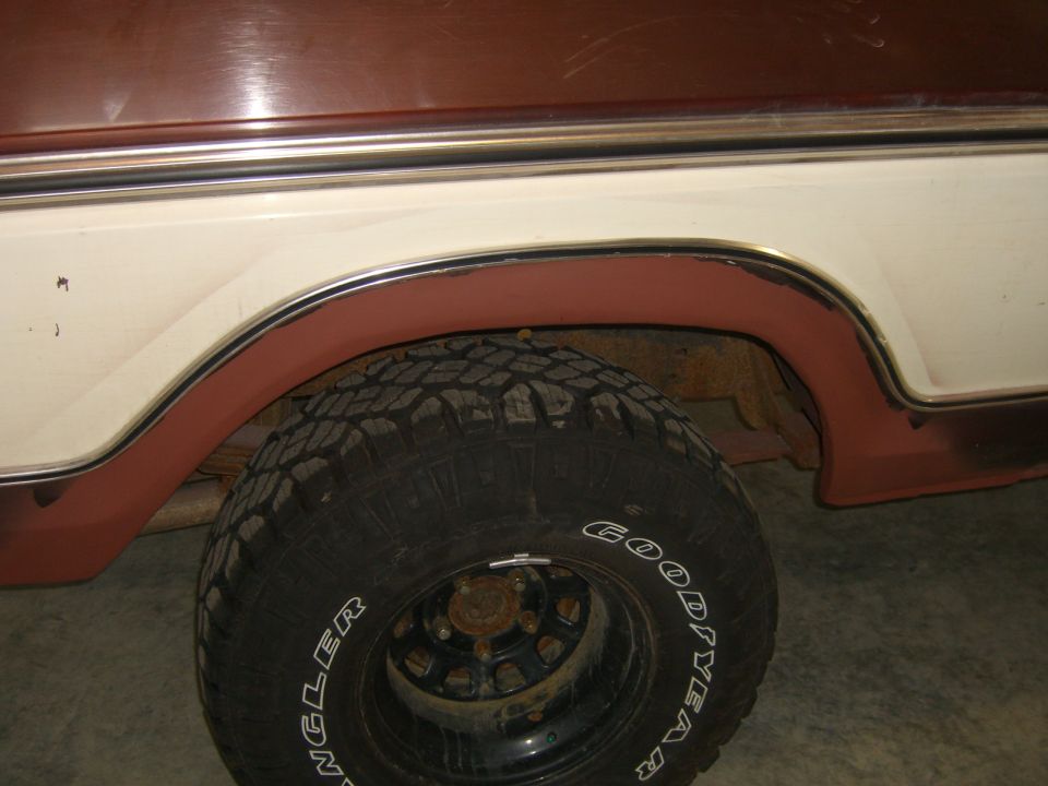Two-tone brown and white 1978 Ford Bronco side view showing the rear wheel well and tire