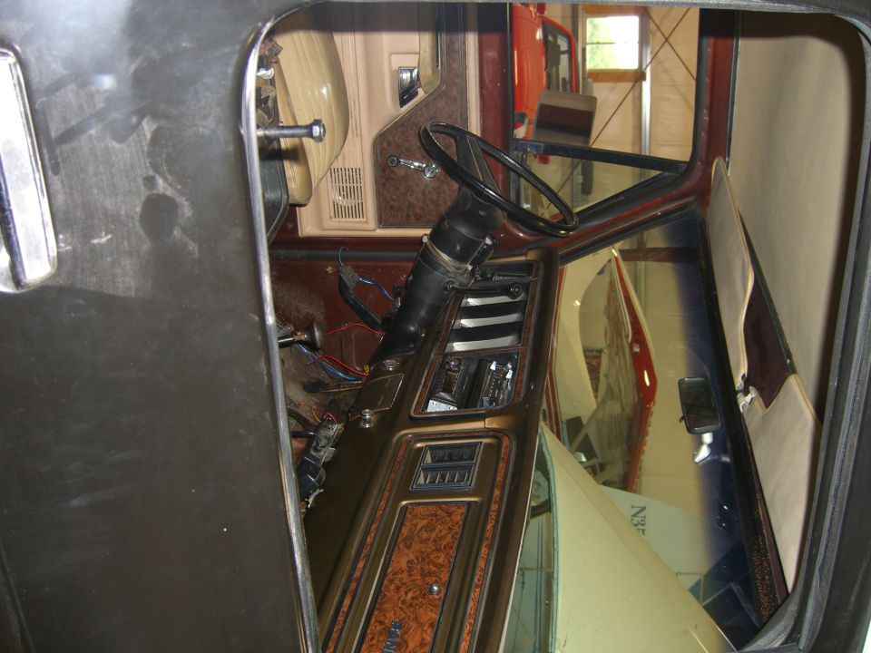 1979 Ford Bronco interior with woodgrain trim and exposed wiring